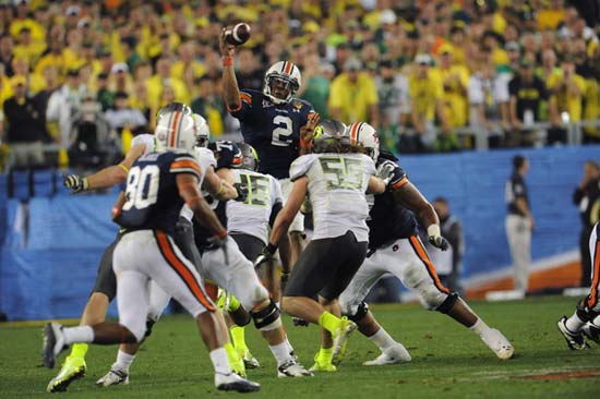 Auburn Tigers QB Cameron Newton passes over the line of scrimmage